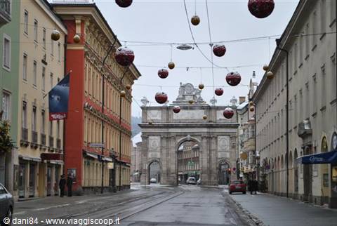 Innsbruck's Triumphal Arch with red Christmas baubles hanging above