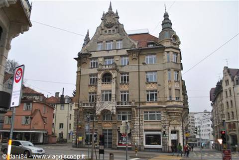 Ornate Art Nouveau corner building among Stuttgart streets, gray sky