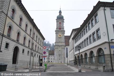 Baroque clock tower between stone buildings in St. Gallen