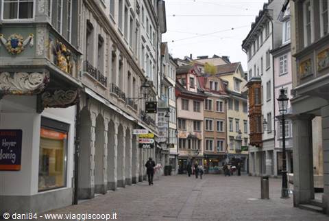 Pedestrian street in Lucerne old town, painted facades and arcades, few walkers