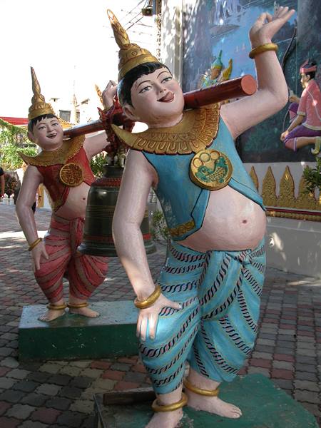 Colorful spirit statues carrying a bronze bell at a temple