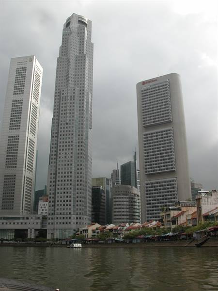 Skyscrapers along the Singapore River, boats and shophouses at Boat Quay
