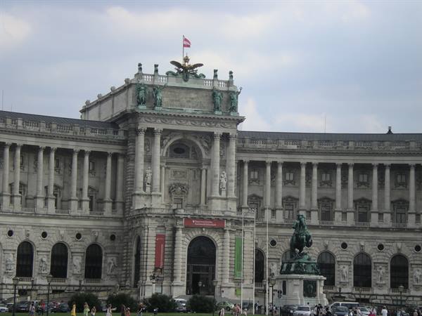 The Neue Burg of the Hofburg in Vienna with the equestrian statue under cloudy sky
