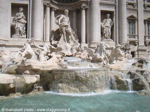 The Trevi Fountain in Rome, marble Neptune statues among cascading water