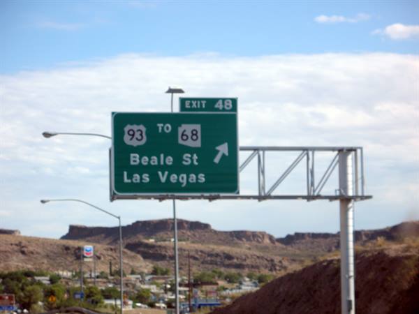 Green highway sign for Beale Street and Las Vegas, exit 48, red mountains behind