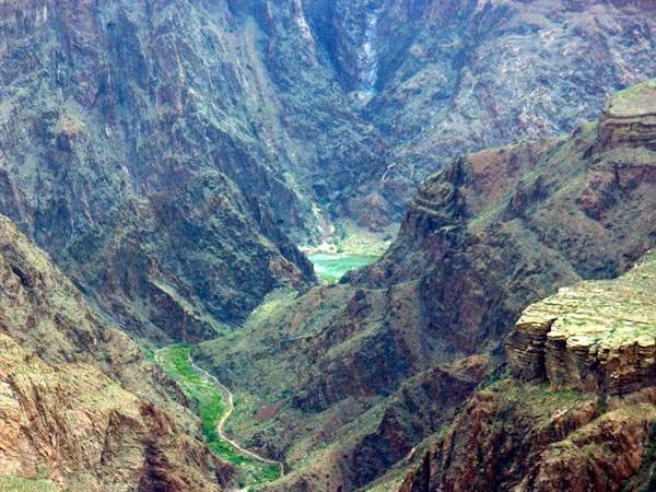 Rocky Grand Canyon floor with the green Colorado River winding between steep walls
