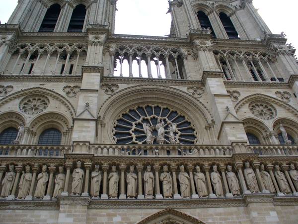 Gothic facade of Notre-Dame in Paris with central rose window and king statues