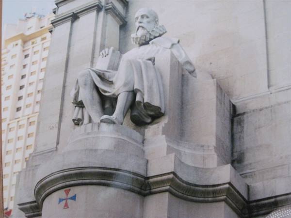 Stone statue of seated Cervantes on the Cervantes monument, Plaza de España, Madrid