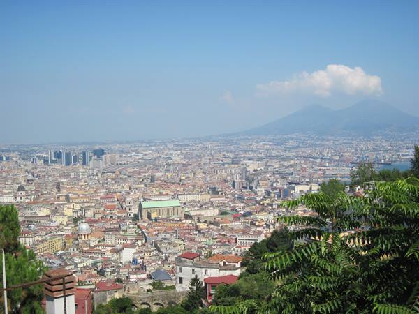 Naples with Mount Vesuvius in the background, rooftops and domes under blue sky