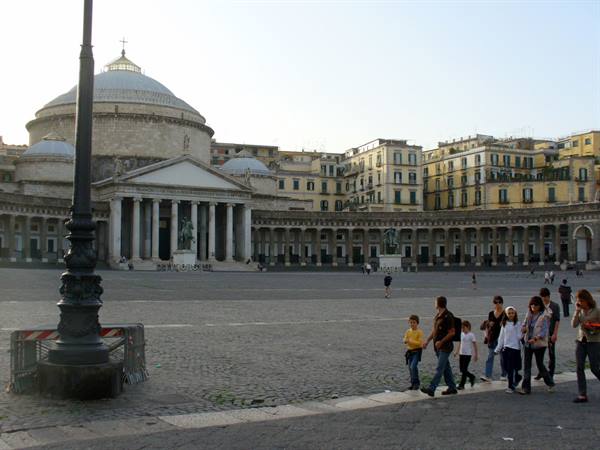 Family walking across Piazza del Plebiscito in front of San Francesco di Paola Basilica