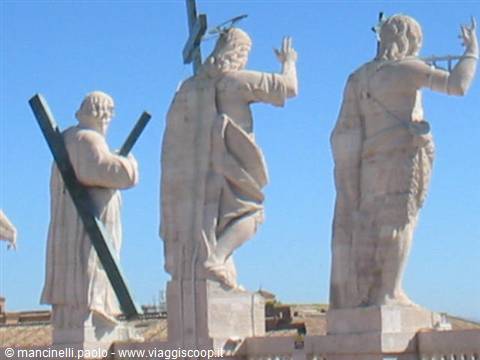 Marble statues of apostles with crosses atop St. Peter's Basilica