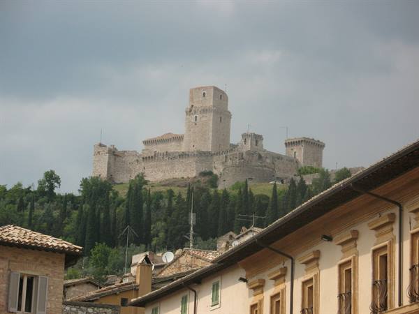 Rocca Maggiore fortress overlooking the rooftops and buildings of Assisi