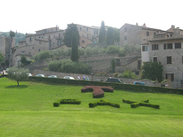 Assisi: hedge shaped into the word PAX before stone houses