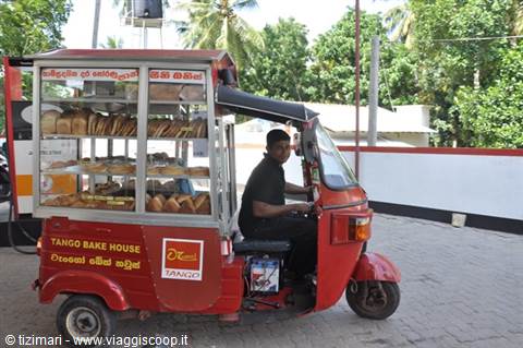 Red tuk-tuk converted into mobile Tango Bake House bakery on the road