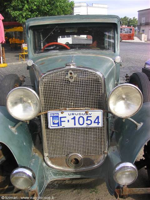 Vintage green car with Uruguayan license plate parked in Colonia's square