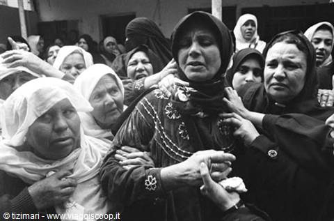 Veiled women weeping at a funeral, black and white photograph