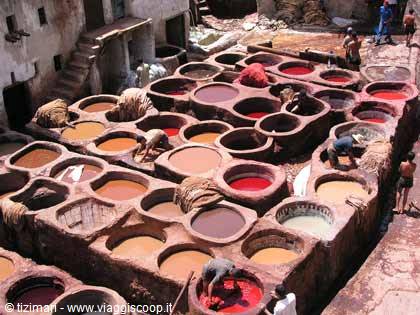Workers tending stone vats filled with dyes at the tanneries