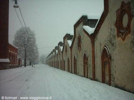 Crespi d'Adda workers' village, sawtooth factory facade under snow