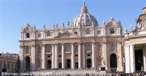 Facade and dome of St. Peter's Basilica, Vatican, under blue sky