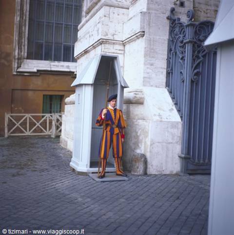 Swiss Guard in yellow and blue uniform beside the sentry box, St. Peter's