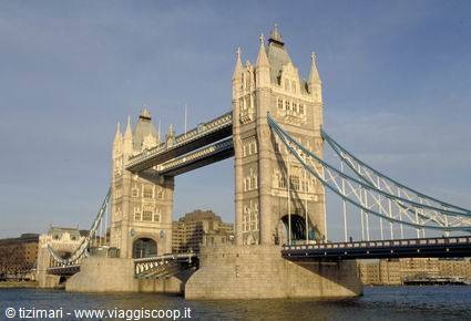 London's Tower Bridge in stone and steel beneath a blue sky