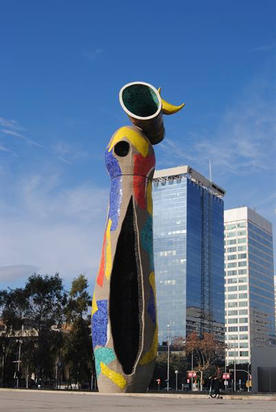 Miró sculpture in Barcelona, colorful mosaic against skyscrapers and blue sky