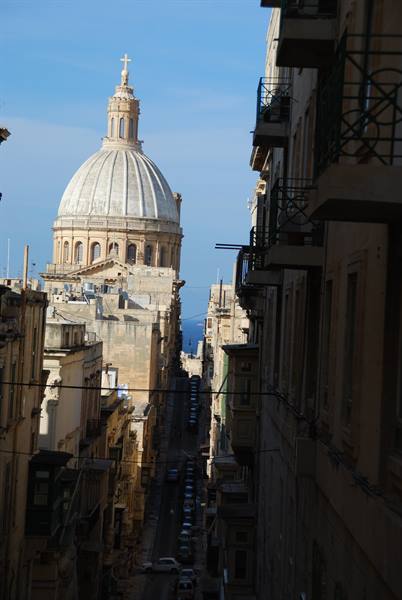 Carmelite church dome rising above Valletta's narrow streets