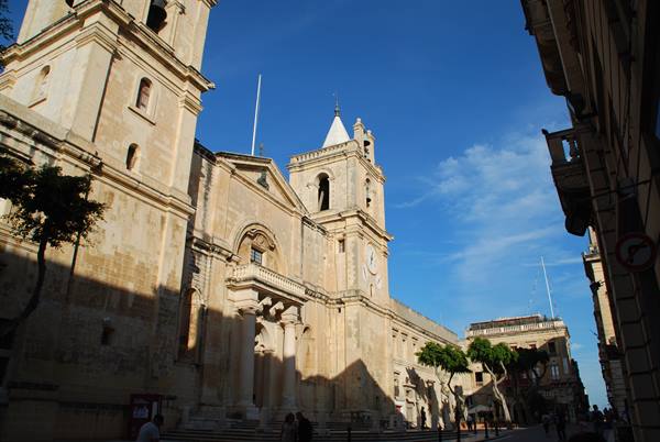 St John's Co-Cathedral in Valletta, golden limestone facade under blue sky