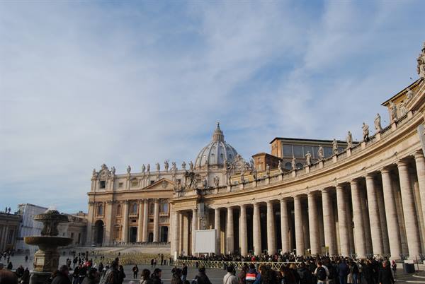 St. Peter's Square: crowd beneath Bernini's colonnade and dome, morning light