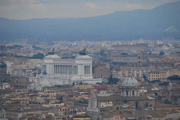 The white Vittoriano monument rises above Rome's rooftops, domes and hazy hills