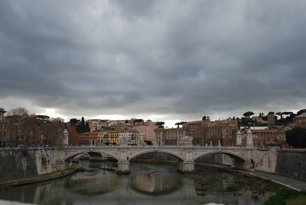Ponte Vittorio Emanuele II over the Tiber, grey clouds above Rome's buildings