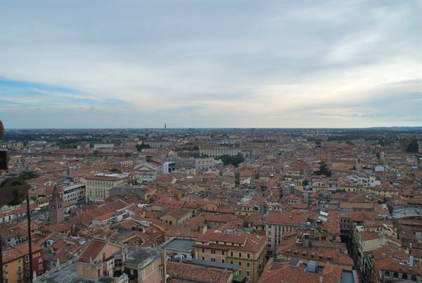 Terracotta rooftops of Verona under a cloudy sky, seen from above