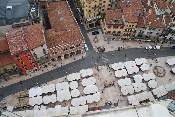 Piazza delle Erbe in Verona from above, white market umbrellas and Gothic buildings