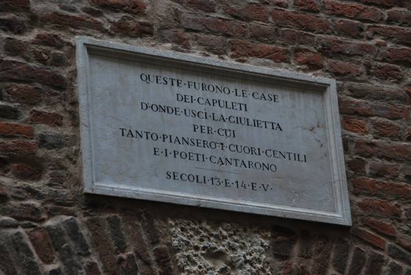 Marble plaque on the Capuleti house in Verona, brick wall