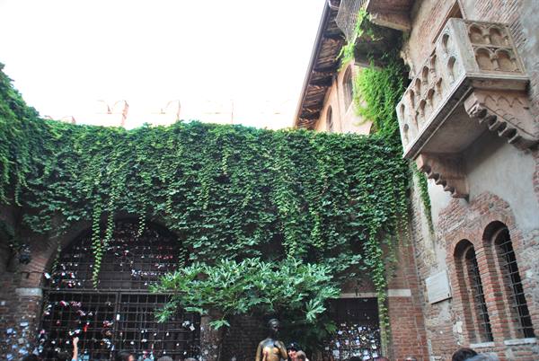 Juliet's balcony in Verona, brick walls, ivy and love padlocks