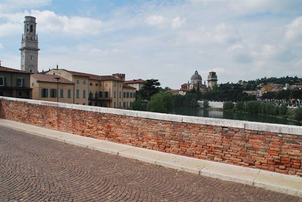Ponte Pietra in Verona: brick parapet, Adige river, bell tower and dome