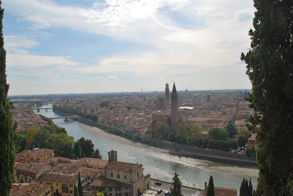 The Adige river flowing through Verona, Lamberti tower among rooftops