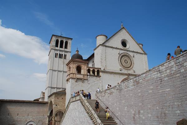 Tourists climb the staircase toward the Basilica of St. Francis in Assisi