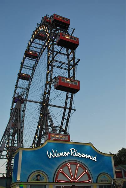 The Wiener Riesenrad ferris wheel with red cabins against blue sky