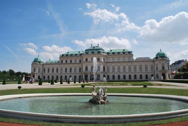 Fountain in front of Belvedere Palace, green gardens, cloudy sky