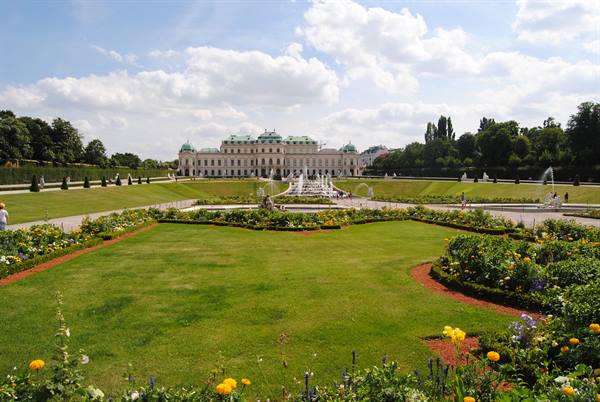Belvedere Gardens in Vienna, green lawn, flower beds and fountains before the palace