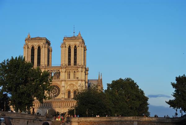 Notre-Dame Cathedral in Paris, Gothic stone towers at dusk