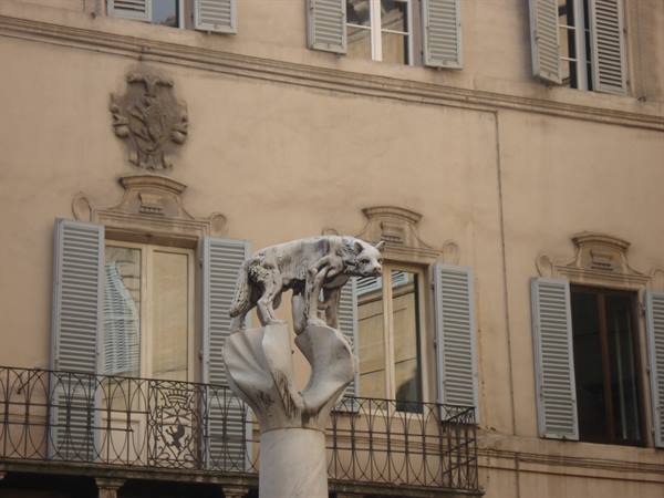 Marble she-wolf statue nursing Romulus and Remus before a Siena palace