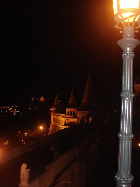 Lit lamppost at night in front of Fisherman's Bastion towers