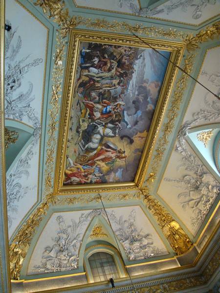 Frescoed ceiling with historical painting in gilded frame and white stuccoes