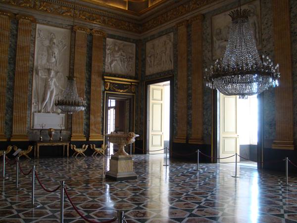 Reggia di Caserta: hall with crystal chandeliers, marble reliefs and inlaid floor