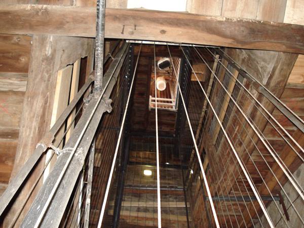 Wire mesh and wooden beams inside a lit shaft