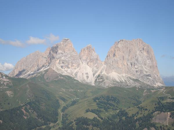 Sassolungo group in the Dolomites, limestone peaks above green meadows