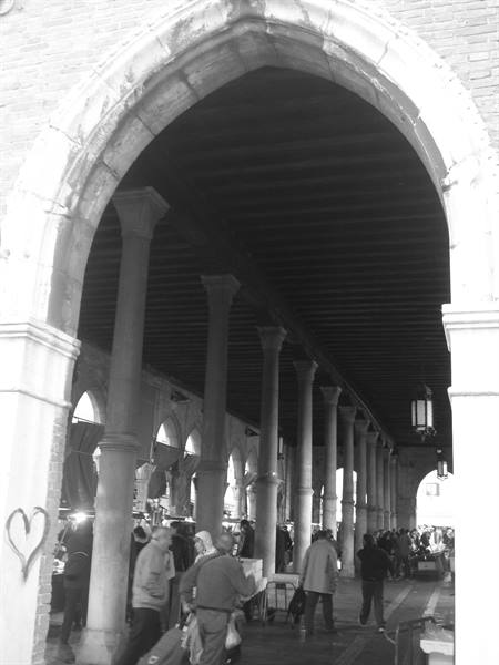 Istrian stone arcade at Rialto, columns and crowd beneath wooden beams