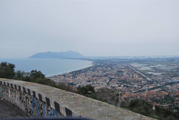 Graffiti-covered wall above the town and coastline toward Mount Circeo